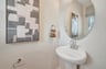 powder room with an oval mirror