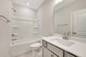 secondary bathroom with a shower and tub combo