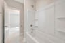 secondary bathroom with a shower and tub combo