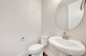 powder room with an oval mirror