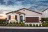 front exterior of brown single-story spanish style home at dusk