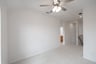 open gameroom with carpet and ceiling fan
