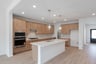 open kitchen with wood floors and island