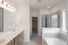 primary bathroom with soaking tub and walk-in shower