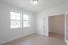 private study with wood floors and windows
