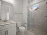 bathroom with quartz countertops & a walk-in shower