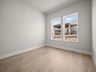 study brown flooring, recessed lighting & a window