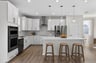 bright kitchen with double-oven and pendant lighting above island