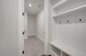 mudroom with a bench with cubbies and hooks