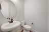 powder room with an oval mirror