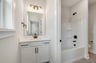 secondary bath with a shower and tub combo