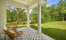 covered patio with two chairs