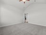 primary bedroom with windows, ceiling fan and carpet
