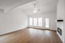 great room with wood flooring and large windows 