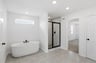 bathroom with white soaking tub and a tile walk-in shower