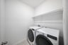 laundry room with washer, dryer, and tile floors