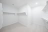 primary bedroom closet with carpet and white shelves