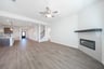 open great room with wood floors and fireplace
