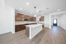 open kitchen with wood floors and island