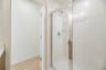 secondary bathroom with a walk-in shower