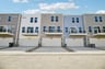 three story townhome rear exterior with a two-car garage
