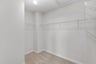 primary bedroom walk-in closet with carpet