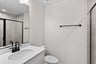 secondary bathroom with a walk-in shower