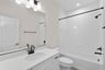 secondary bathroom with a shower & tub combo