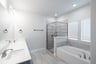 primary bathroom with soaking tub and walk-in shower