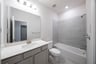 bathroom with bathtub and white countertops 
