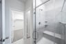 walk-in shower with glass doors and tile 