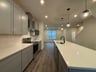 kitchen with white countertops and pendant lighting