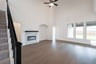 open great room with wood floors and fireplace