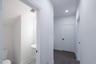 mudroom with wood floors and white shelves with bench