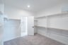 primary bedroom closet with carpet and white shelves