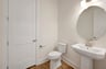 powder room with a pedestal sink and an oval mirror