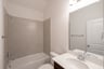 bathroom with tub and white countertop 