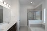bathroom with tub and walk-in shower