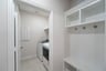 laundry room with tile and white shelves