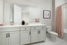 bathroom with white cabinets & counters, pink towels, tub with shower overhead, and pink & white shower curtain