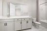 bathroom with white cabinets & counters, and tub with shower over head