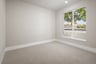 bedroom with tan carpet, tan walls, window, and recessed ceiling lights