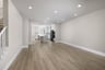 great room with wood floors, recessed ceiling lights, and view of kitchen