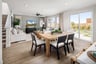 dining room with wood floors, wood table with six chairs, and sliding glass door to the backyard