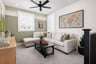 loft with green wall, white sofa, windows, and black coffee table