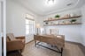 open study with hardwood flooring and glass french doors