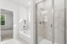 primary bath with walk-in shower and soaking tub
