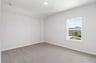 secondary bedroom with carpet, window and a sloped ceiling